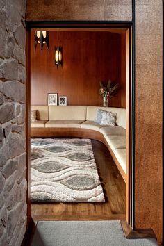 a living room with stone walls and wood paneling