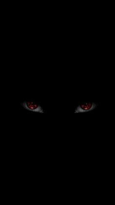 red eyes are glowing in the dark, with only one eye visible to the left