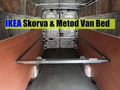 the inside of an empty van that is painted white and has yellow lettering reading ikea storva & metod van bed