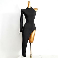 a mannequin with a black dress on it's head and neck, in front of a white wall