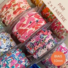 several rolls of colorful floral printed ribbon on display