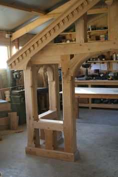 an unfinished wooden structure in a workshop