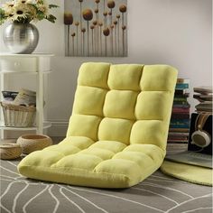 a yellow chair sitting on top of a carpet covered floor