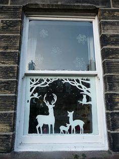 an image of a window with deer and snowflakes on it