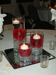 candles are lit on top of the centerpieces