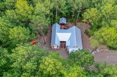 an aerial view of a house surrounded by trees