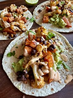 three tortillas filled with different types of food