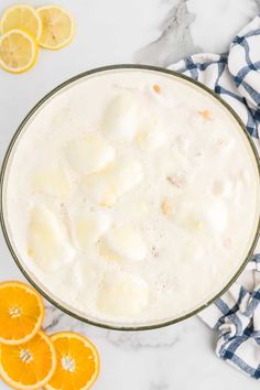 a glass bowl filled with milk and orange slices