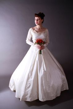 a woman in a white wedding dress holding a bouquet