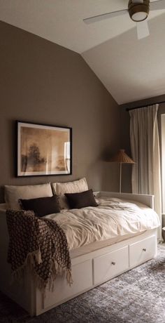 a bedroom with a large bed and two lamps on either side of the window sill