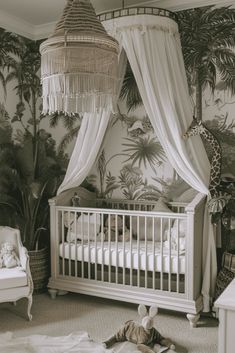 a baby's room with a canopy bed and jungle wallpaper