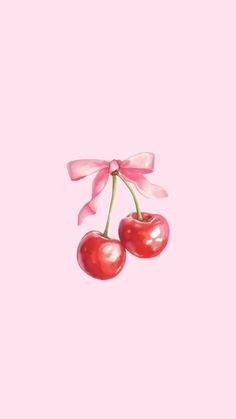 two cherries tied to a pink ribbon on top of each other in front of a pink background