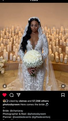 a woman in a wedding dress holding a bouquet and posing for the camera with candles behind her