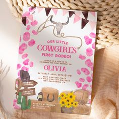 a pink and white cowgirl's first rodeo birthday party card on a basket