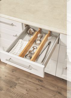 an open drawer with utensils in it