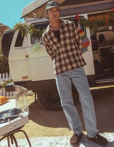 a man standing in front of a camper