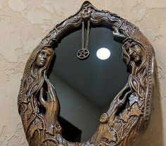 a mirror hanging on the side of a wall