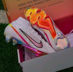 a pair of nike soccer cleats in a box