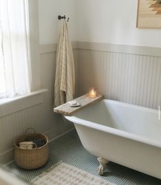 a white bath tub sitting next to a window