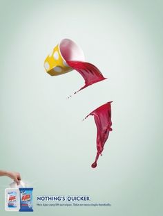 red liquid pouring out of a yellow and white cup into the air on a light blue background