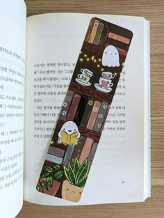 an open book with some stickers on it and a cup of coffee in the middle