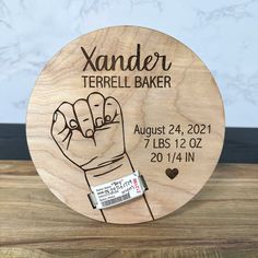 a wooden plaque with a hand drawn on it that says xander terrell baker