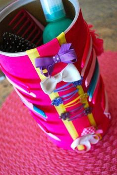 a cup with some hairbrushes and other items in it on a pink mat