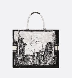 Introduced by Maria Grazia Chiuri, Creative Director of Christian Dior, the Dior Book Tote has become a staple of the Dior aesthetic. Designed to hold all the daily essentials, it is fully embroidered with the white and black New York motif, a pillar of the collection that celebrates the city's skyline and the Statue of Liberty in a graphic spirit. Adorned with a contrasting Christian Dior Paris signature on the front, the large tote exemplifies the House's savoir-faire and may be carried by han Christian Dior Handbags, Dior Aesthetic, Black New York, Dior Book, Christian Dior Paris, Dior Paris, Dior Book Tote, The Statue Of Liberty, Maria Grazia Chiuri