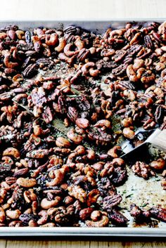 a pan filled with nuts on top of a wooden table