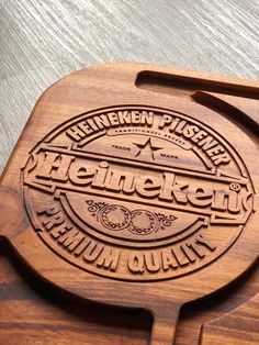 a wooden cutting board with the name heinekenn pleiself on it