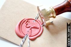 a rubber stamp with the letter y on it and a pair of scissors next to it