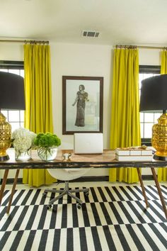 a black and white checkered floor in front of yellow drapes with two lamps on each side