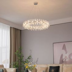 a living room filled with furniture and a chandelier hanging over the top of it