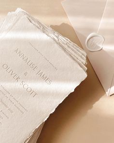 the wedding stationery is laid out on top of each other