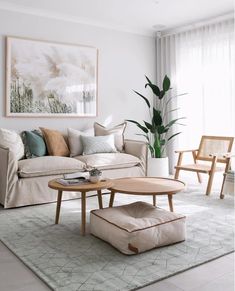 a living room filled with furniture and a painting on the wall above it's coffee table