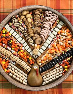 a turkey shaped platter filled with cookies, crackers and candy