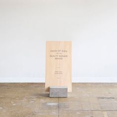 a piece of wood sitting on top of a wooden floor next to a white wall