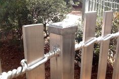 a close up of a metal fence with ropes