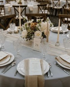 the table is set with place settings and silverware for an elegant dinner party or reception