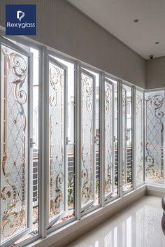 an empty room with white walls and glass doors on the outside, looking out onto a balcony