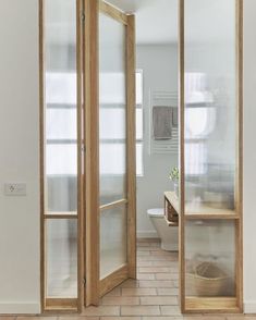 an open door leading to a bathroom with tiled floors