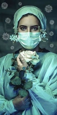 a woman wearing a surgical mask and holding a rose