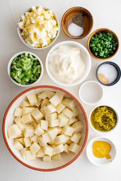 an assortment of food is arranged in bowls on a table top, including potatoes, peas and other ingredients