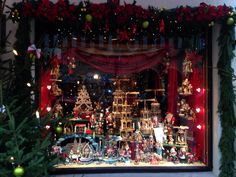 a christmas window display with ornaments and lights