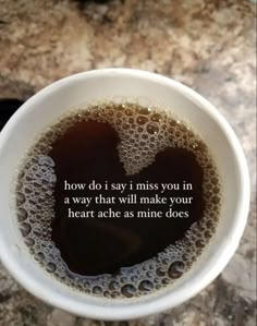 a white cup filled with liquid on top of a counter