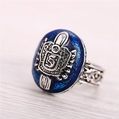 a blue ring with an ornate design on it