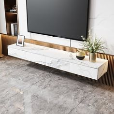 a large flat screen tv mounted to the side of a wall in a living room