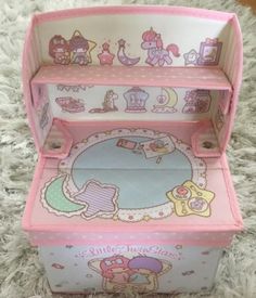 a pink toy chest sitting on top of a white carpet next to a stuffed animal