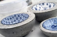 three blue and white bowls sitting next to each other