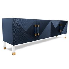 a blue and white sideboard with two gold handles on the front, one door open to reveal an interesting geometric design